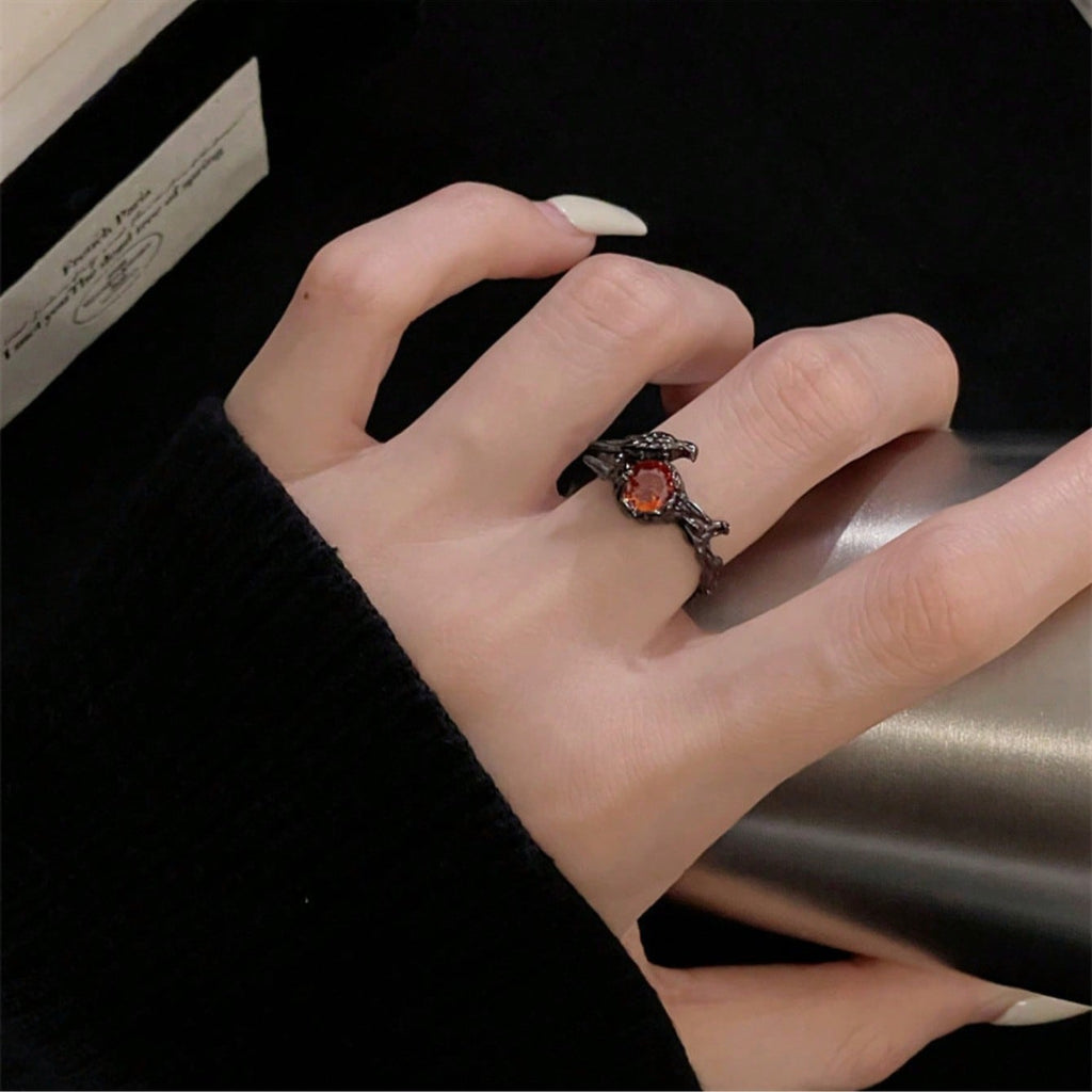 Gothic Black Bird And Red Gemstone Ring – Unique Adjustable Statement Ring Featuring Detailed Black Metal Bird Perched On Nest Setting With Sparkling Red Gemstone Center, Intricate Vintage-Inspired Design, Comfortable Adjustable Band For Various Finger Si
