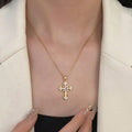Elegant Gold Tone Cross Pendant Necklace With Sparkling Cubic Zirconia – Exquisite Religious Jewelry Featuring Ornate Cross Design Adorned With Brilliant Cubic Zirconia Stones, Including A Larger Oval Center Stone – High-Quality Gold Tone Finish For Timel